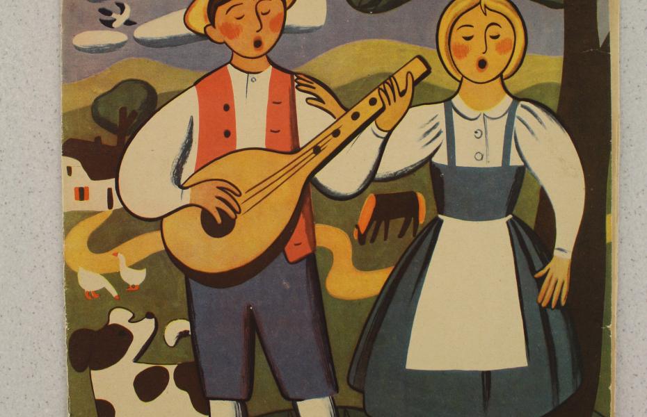 Das Bild zeigt das Jugendheft "Die Schulpost". Abgebildet sind ein junge und ein Mädchen in Tracht, welche singen. Das cover ist farbig.